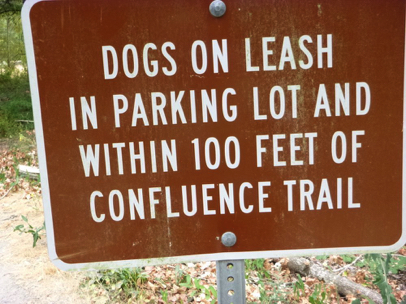 Dogs on leash in parking lot and within 100 feet of Confluence Trail